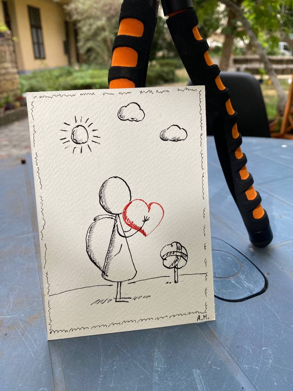 A physical Heart & Angel postcard, photographed as a real object